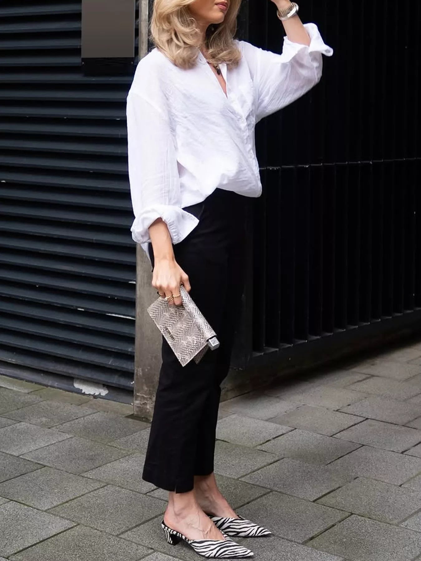 White textured button down shirt for women styled with black cropped pants and statement flats
